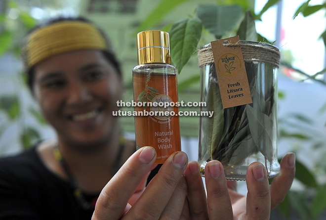 Jena Libang from Bario shows LitSara essential oil body wash and fresh Litsea cubeba leaves.