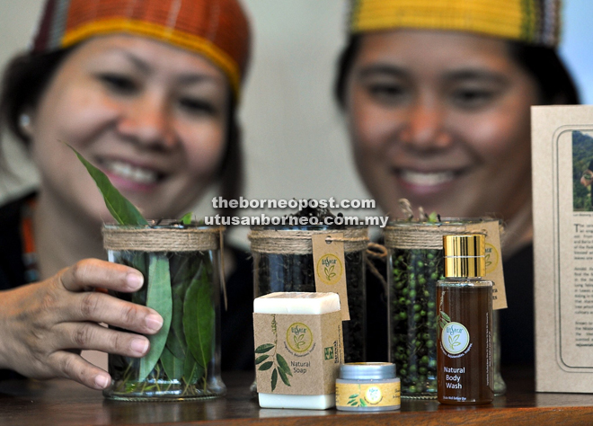 Roslind John (left) and Jena Libang from Bario show LitSara essential oil products derived from the fruits and leaves of the Litsea cubeba tree. 