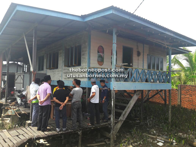 Family members and relatives gathering in front of the house yesterday morning where the tragedy occured.