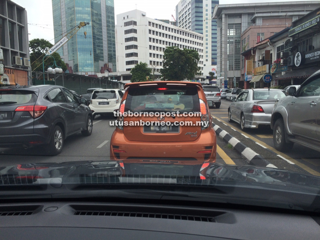 Traffic jam at the Golden Triangle in Kuching during peak hours yesterday.