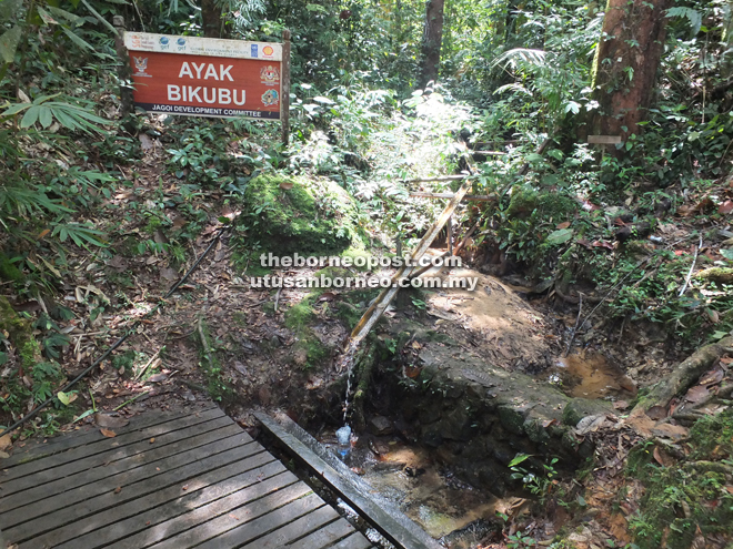 Hikers can stop by the gravity-feed water fountain for a cool and refreshing drink before going up the final flight of cement stairs to the village at the top of Bung Jagoi.