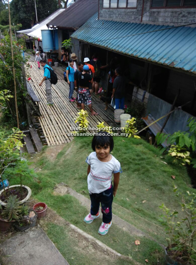 Little Li Jing poses for the camera upon reaching the village.