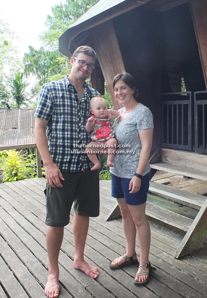 Young, Burruss and their little daughter have their photo taken in front of a ‘baruk’ — traditional Bidayuh ‘skull’ house.