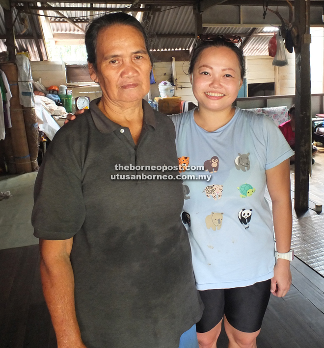 Jema (left) with Ng at her family home on the mountain-top.