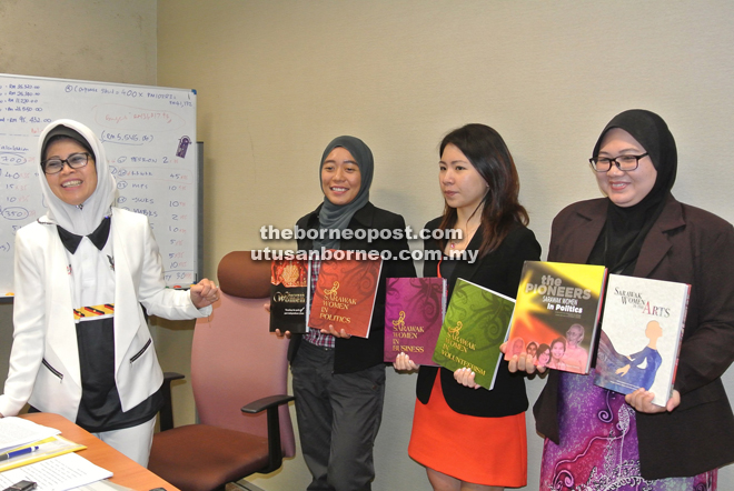 Fatimah smiles while her ministry’s staff pose with the six published books. — Photo by Hiew Man Chien