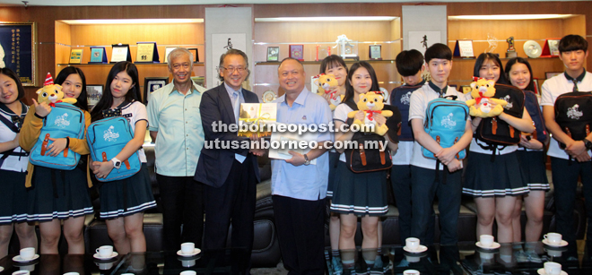 Park (fifth left) and Chan exchange mementoes. At fourth left is Kuching North Datuk Bandar Datuk Abang Abdul Wahap Abang Julai.