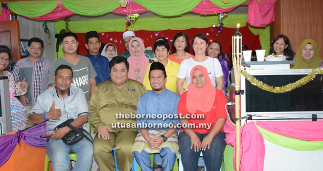 Mohd Fakri (seated second right) and staff in a photo call with guests. 