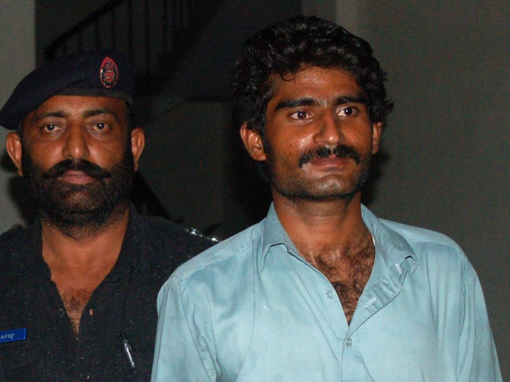 Waseem (R), brother of Qandeel Baloch, a social media celebrity, is escorted by police after arrest in Multan on July 16, 2016. Photo by AFP