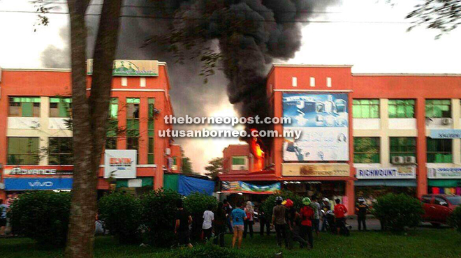 The fire at its height in Medan commercial area, Mukah, yesterday.