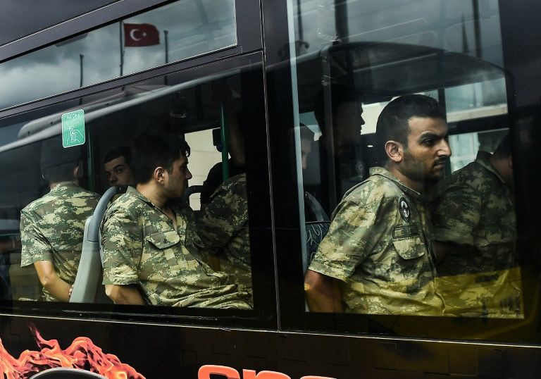 Detained Turkish soldiers who allegedly took part in a military coup arrive in a bus at the courthouse in Istanbul. Photo by AFP