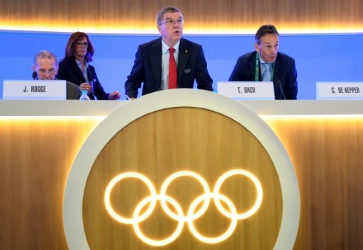 IOC President Thomas Bach (C) looks on next to former IOC President Jacques Rogge (L) and IOC Director General Christophe De Kepper at the opening of the 129th International Olympic Committee session, in Rio de Janeiro on August 2, 2016 by Eric Bernaudeau, Talek Harris | AFP photo
