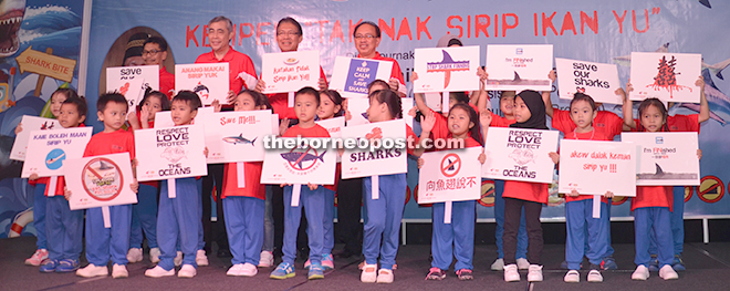 HAVE A HEART FOR SHARKS: (Back row, from left) Department of Fisheries Malaysia head (Marine Resource Management Branch) Mohamad Noor Nordin, PBB publicity chief Datuk Yusuf Sani Wahab, Assistant Minister of Rural Economy (Coastal Areas) and Fisheries Datuk Julaihi Narawi and Sarawak Marine Fisheries Department deputy director Bohari Leng together with children holding signboards appealing for public support towards the ‘Say No To Shark Fin’ campaign. — Photo by Norni Mahadi