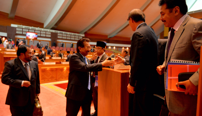  Musa shaking hands with assistant ministers at the end of the State Assembly sitting yesterday.