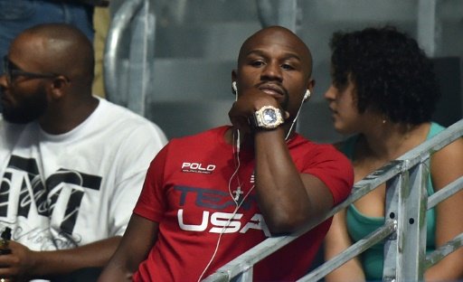 Retired boxer Floyd Mayweather Jr. (centre) attends a boxing match at the Rio Olympic Games on Aug 13, 2016. Photo by AFP