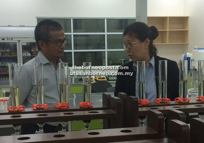 Lulie (right) briefs Dr Annuar on the functions of various labs at the new TPRL in Kota Samarahan.