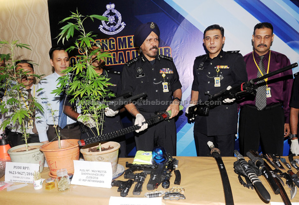 Amar Singh (third right) showing a samurai sword among the items seized from the bungalow during a press conference at Kuala Lumpur Police Headquarters. — Bernama photo