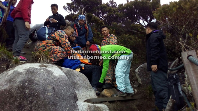 MOSAR team members taking turns to carry the victim down Mount Kinabalu on Wednesday. 