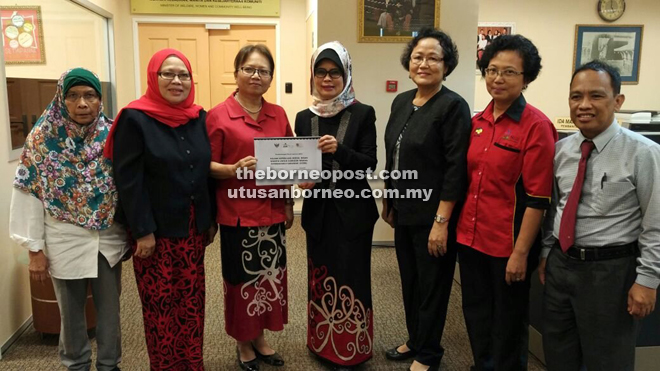 Fatimah (centre) and Madeline (third left) hold the report on the Study on Women Labour Force Needs for SCORE. Also seen are (from right) Abdul Hair, Camilla, Megir, Faridah and Siti Rohani.  