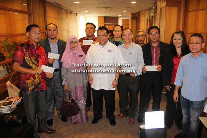 Nanta (centre) in a group photo with the recipients after the presentation of grants at his office.