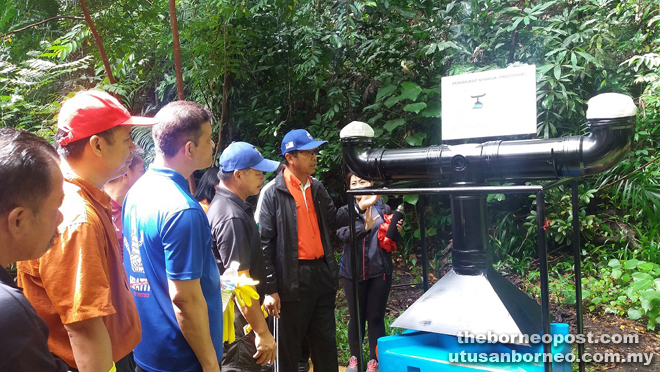 Kamarlin (right) looking at the prototype created by the state Museum staff to capture mosquitoes and their larvae and terminate them. 