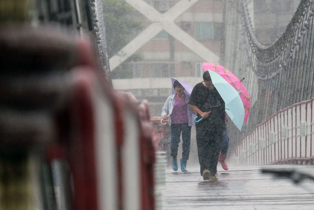 Residents shelter from rain in the New Taipei City, as Typhoon Megi approaches eastern Taiwan, on Sept 27, 2016. AFP Photo