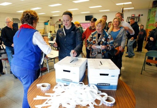 Kentucky voters place their paper ballots in the box in a GOP presidential caucus on March 5, 2016, in Louisville, Kentucky, Sébastien Blanc | AFP photo