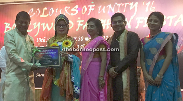 Fatimah (second left) receiving a souvenir from Narayanan at the launching of the event.