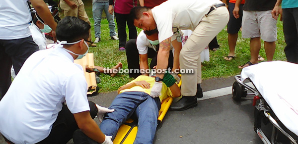 Medical personnel attending to the injured female rider.