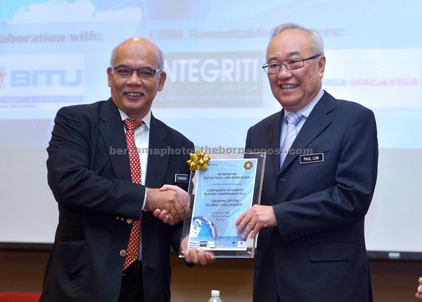 Low receives an appreciation plaque from MACC deputy chief commissioner (prevention) Datuk Shamshun Baharin Mohd Jamil (left) during the Conference on Corporate Integrity Pledge (CIP) 2016. —Bernama photo