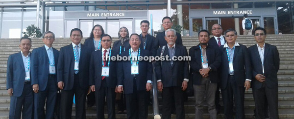 Dr Rundi (front row, fourth left) and members of his entourage at the main entrance of Brisbane Convention and Exhibition Centre, Australia. 