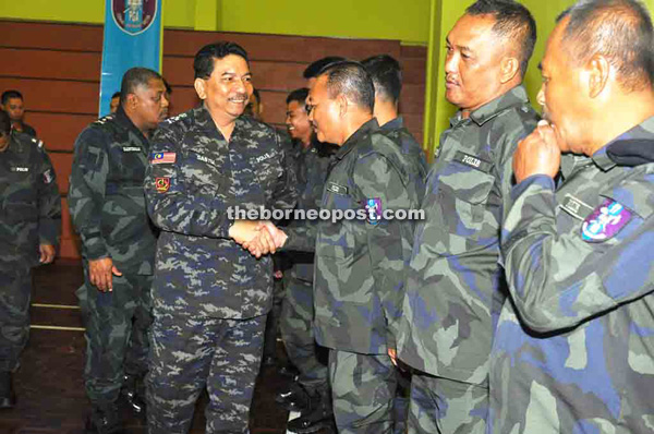 Muhammad shaking hands with GOF personnel during his working visit to the Sabah GOF headquarters in Kinarut yesterday.   