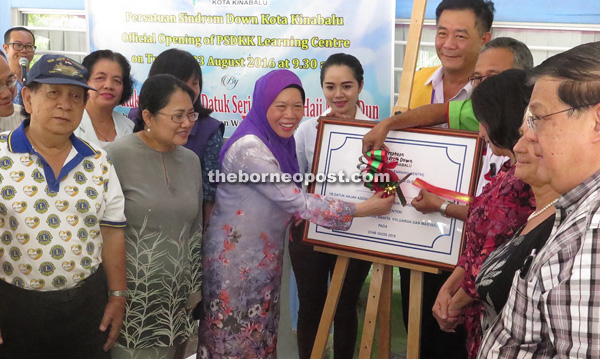Azizah (third left) officiating at the Kota Kinabalu Down Syndrome Association learning centre at Taman Orkid yesterday.