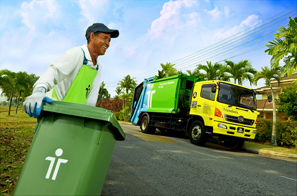 A worker collecting municipal household waste in Kuching.