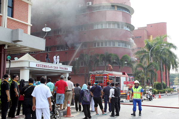 Firefighters try to control the fire on the second floor of southern ICU unit of Sultanah Aminah Hospital in Johor Bahru. — Bernama photo