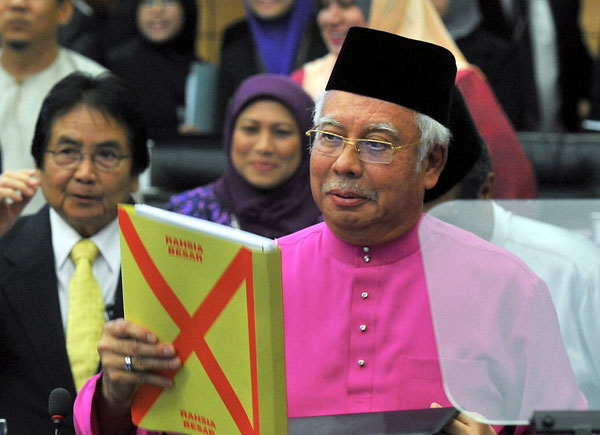 Najib holds the budget text before tabling Budget 2017 in parliament. — Bernama photo
