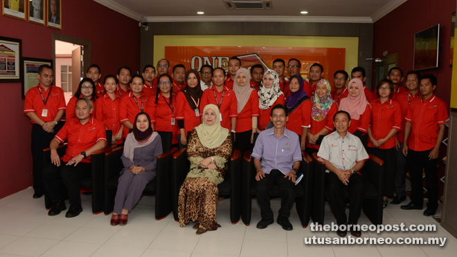 Jamilah (seated centre) is seen in a photocall with the staff of Sri Aman Welfare Department.