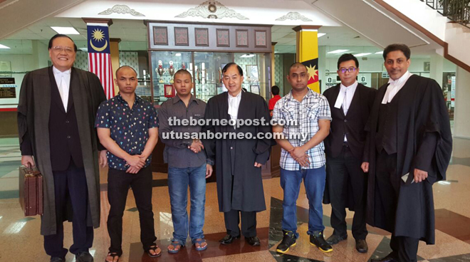 Sim (left), Lim (fourth left), Shankar (second right) and Ling (right) with their clients after the judgement.