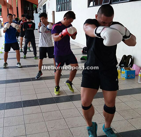 Stephen (right) training with the Sabah boxing team.