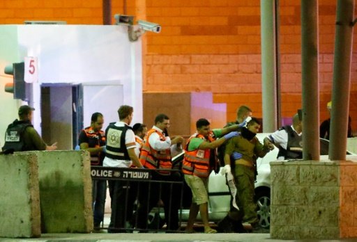 Israeli medical staff walk an injured soldier (2nd right) following a stabbing attempt at the Qalandia checkpoint between the West Bank city of Ramallah and Jerusalem on September 30, 2016 -AFP photo