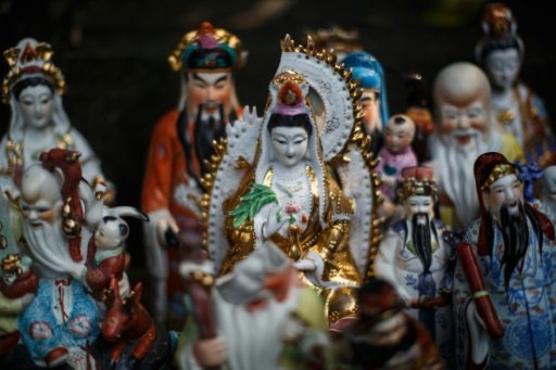 Unwanted statues of deities, gathered and repaired after their owners discarded them, perch on a rocky slope in Hong Kong. AFP Photo