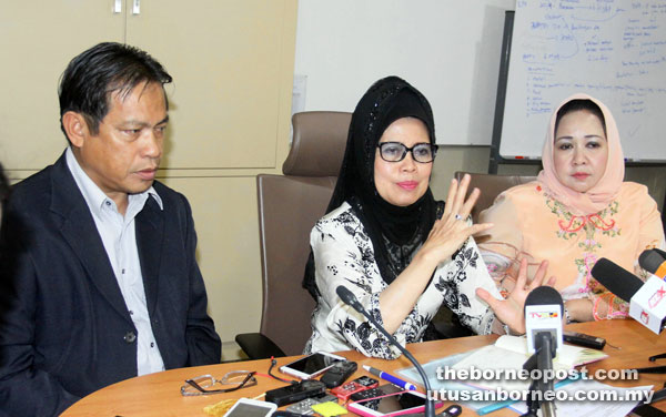 Fatimah (centre) explaining a point to reporters during the press conference after chairing a meeting on the progress report of the 90:10 policy while Dr Abdul Rahman (left) and Sharifah Hasidah look on. — Photo by Jeffery Mostapa