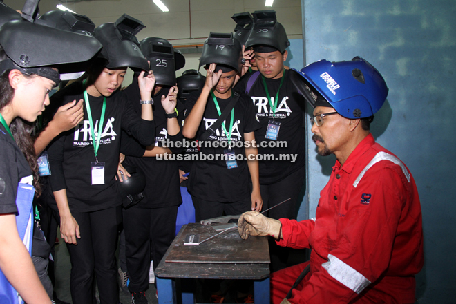 Participants being briefed by a PKS lecturer on welding. — Photo by Chimon Upon