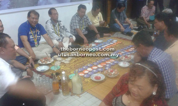 Ugak (left) performing the traditional Iban miring ceremony accompanied by  Billy and Belayong during the gathering.