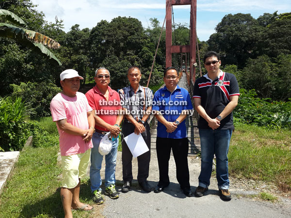 Minggu (second right) and Kong Sien Jong (centre) are seen at the site during a recent visit.