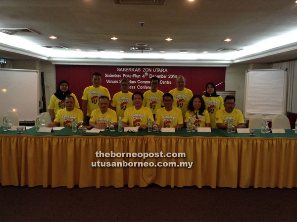 Dennis (seated fourth right) with the organising committee.