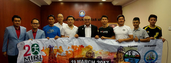 During a courtesy call on Miri mayor Adam Yii are (from left) Wong, Liew, race manager Tang Swee Ming, Cr Leong, Ling, Yii and the organising committee holding the banner of Miri Marathon 2017.