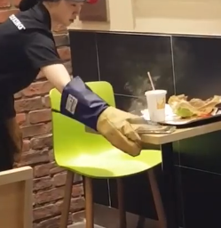 A Burger King employee in Incheon, South Korea attempts to remove a smoking Samsung Galaxy Note 7 with insulated gloves.