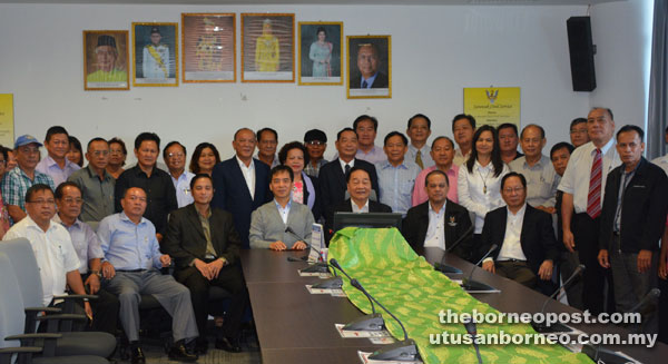 Wong (seated third right), Hii (seated fourth right), Lau (seated right), Stanley (seated third left) and others posing for a group photo.