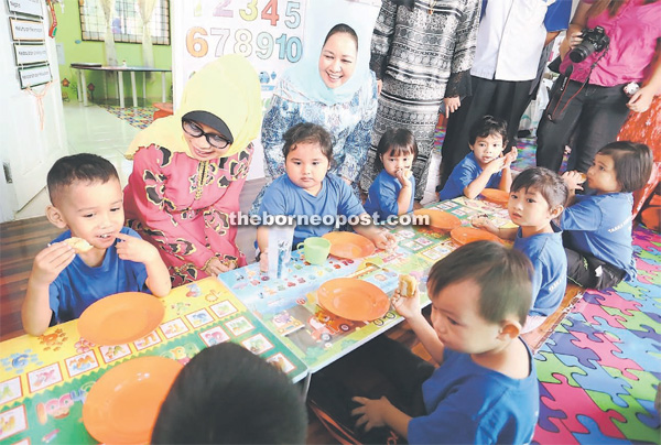 (From left) Fatimah and Sharifah Hasidah share a light moment with the preschoolers at Taska Kemas Kampung Bawang.