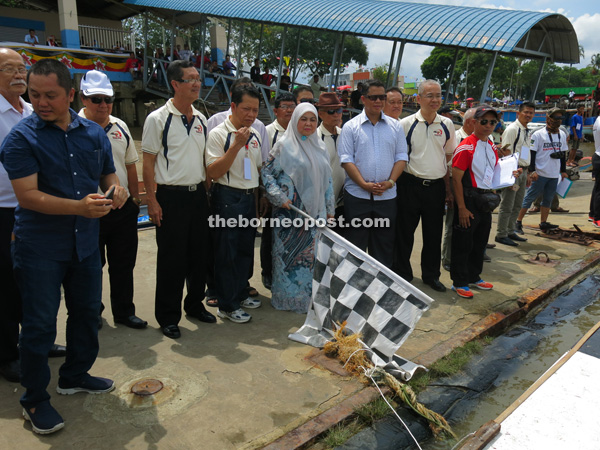 Norah (sixth left) flagging off one of the events at the Sarikei Powerboat GP race.